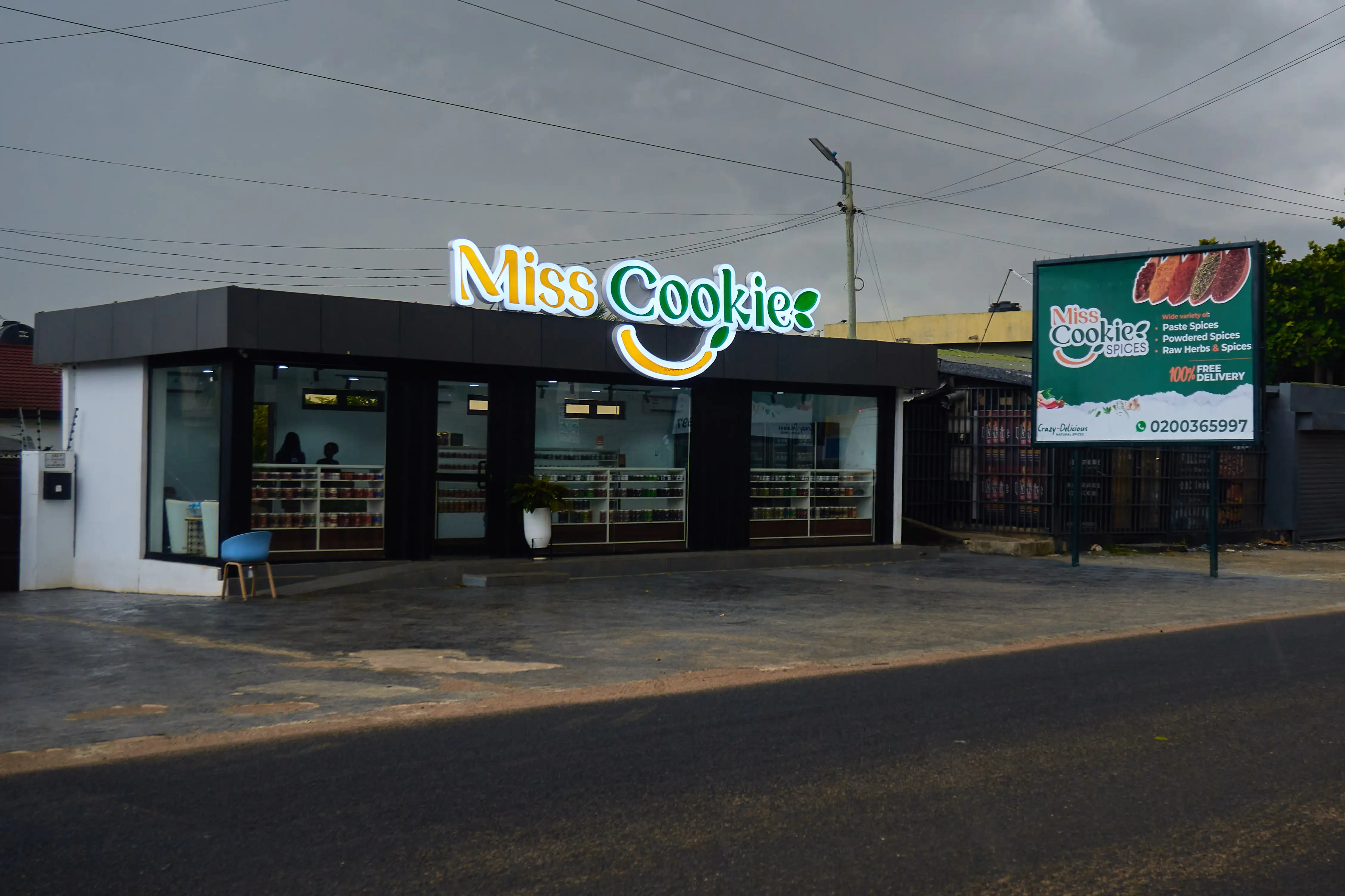 The Miss Cookie Spices shop at American House, East Legon, its shelves of spice jars visible through the front windows