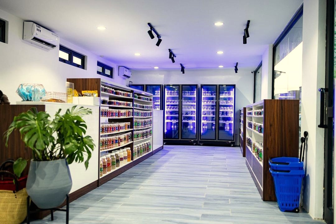 Inside the Miss Cookie shop, shelves of spice jars running the length of the room towards lit display fridges